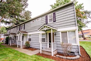 the front of a gray house with a porch at Pacific Walk, Lakewood, Washington